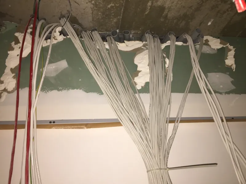 Cables pulled through the wall of a new office before the ceiling closes