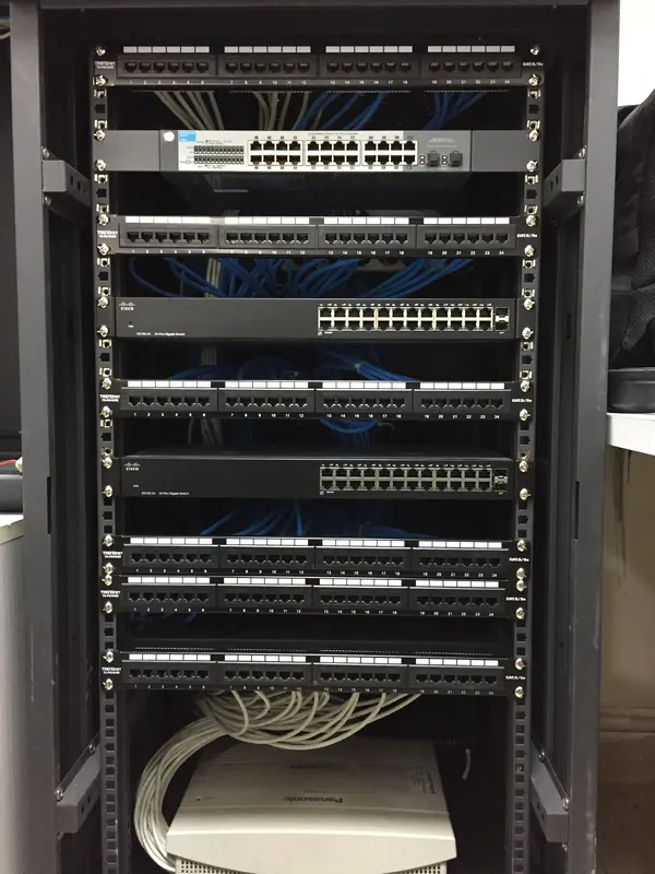 A cabinet with switches and patch panels, every cable in its place