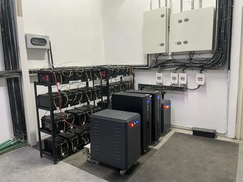 Inverters and a rack of batteries in the plant room