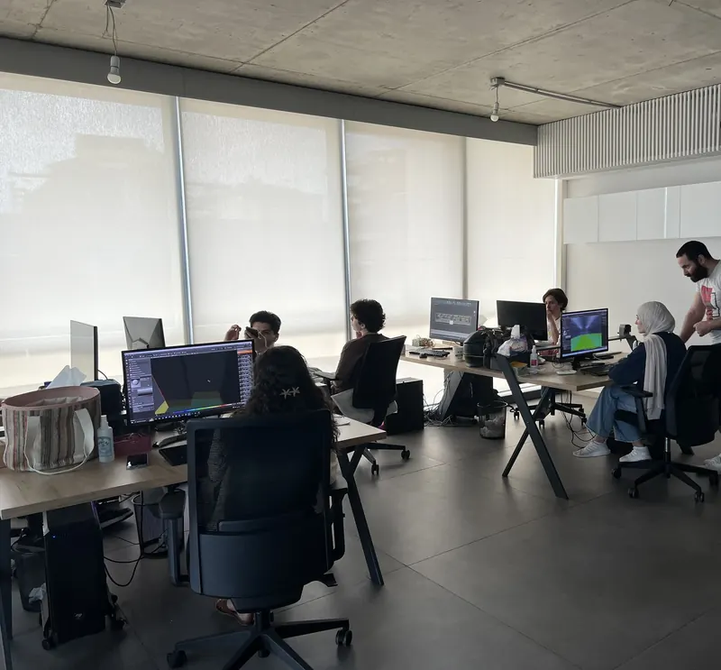 An open plan office, the team at their screens